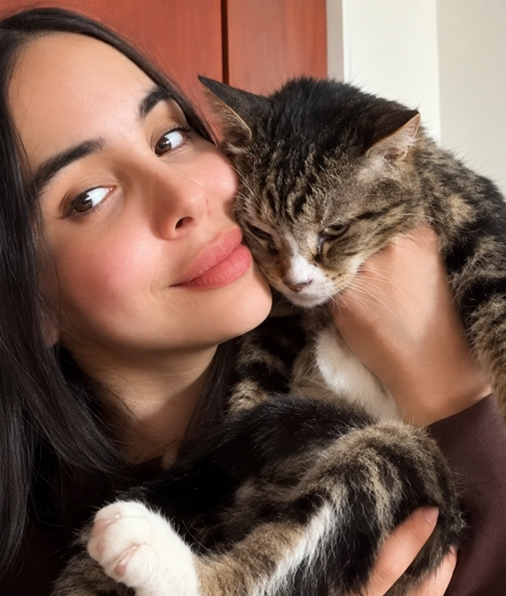 Vanessa holding a rescued cat close to her